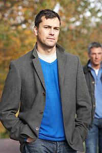 Two Men Standing Outside In Autumn Woodland