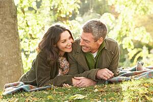 Romantic Couple Relaxing Outdoors In Autumn Landscape