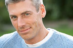 Close Up Portrait Of Man Standing Outside In Autumn Landscape