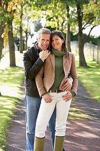 Portrait Of Romantic Couple Enjoying Outdoor Walk Through Autumn Park