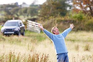 Man Enjoying Freedom Outdoors in Autumn Landscape