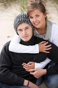 Young Romantic Couple Relaxing On Beach Together