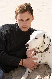 Portrait Of Teenage Boy On Beach With Dog