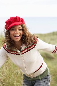 Teenage Girl Walking Through Sand Dunes Wearing Warm Clothing