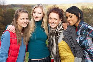 Group Of Four Teenage Female Friends In Autumn Landscape
