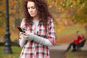 Frustrated Teenage Girl Making Mobile Phone Call In Autumn Landscape