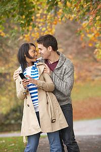 Romantic Teenage Couple In Autumn Park