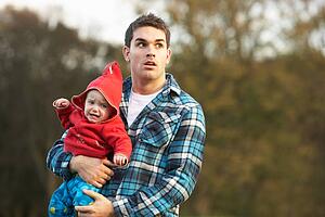 Shocked Teenage Boy Holding Baby