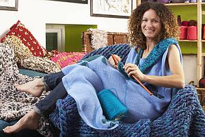 Woman Sitting In Chair Knitting
