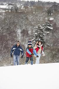 Family Having Fun In Snowy Countryside