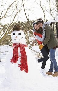Teenage Couple Building Snowman