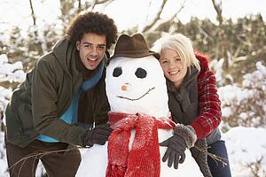 Teenage Couple Building Snowman