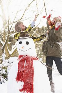 Teenage Couple Building Snowman