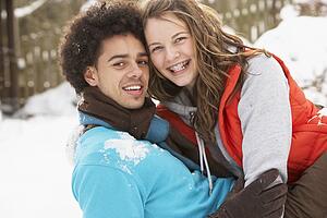 Romantic Teenage Couple Having Fun In Snow