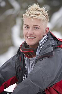 Teenage Boy Wearing Winter Clothes In Snowy Landscape