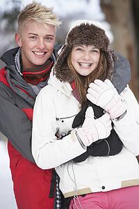 Romantic Teenage Couple In Snow