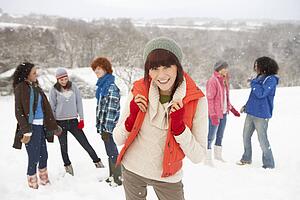 Group Of Young Friends Having Fun In Snowy Landscape