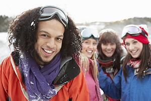 Group Of Teenage Friends Having Fun In Snowy Landscape Wearing Ski Clothing