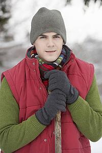 Young Man Clearing Snow From Drive