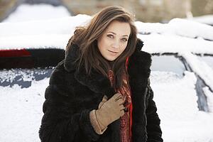 Close Up Of Teenage Girl Wearing Fur Coat In Snowy Landscape