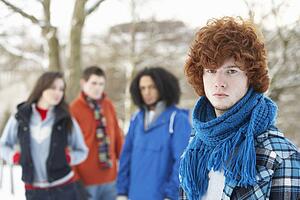 Group Of Teenage Friends Having Fun In Snowy Landscape Wearing Ski Clothing