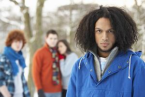 Group Of Teenage Friends Having Fun In Snowy Landscape Wearing Ski Clothing