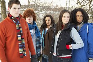 Group Of Teenage Friends Having Fun In Snowy Landscape Wearing Ski Clothing