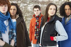 Group Of Teenage Friends Having Fun In Snowy Landscape Wearing Ski Clothing