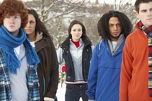 Group Of Teenage Friends Having Fun In Snowy Landscape Wearing Ski Clothing