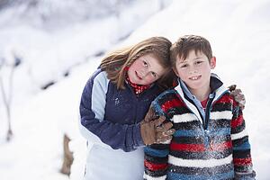 Portrait Of Two Children In Snowy Landscape