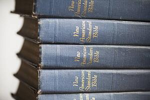 a pile of copies of the new american standard bible