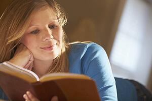 a young woman reading a book