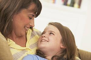 a mother and daughter looking at each other