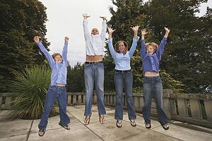 a family jumping in the air together