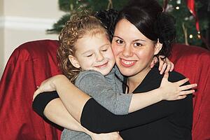 a mother hugging her daughter