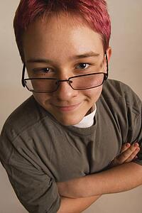 a boy with red hair and eye glasses sliding down his nose