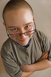 a boy with eye glasses sliding down his nose
