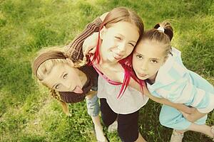edmonton, alberta, canada; three girls sticking out their tongues