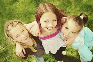 edmonton, alberta, canada; three girls in an embrace