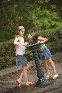 edmonton, alberta, canada; two girls at a drinking fountain
