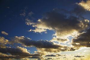 edmonton, alberta, canada; sun shining around clouds