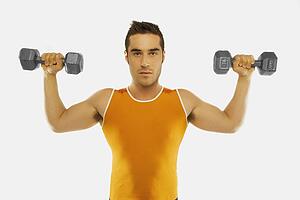 a man lifting two free weights