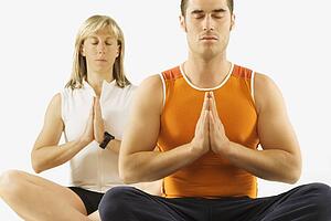 man and woman in a yoga pose