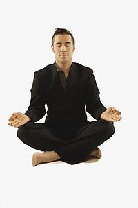 businessman in a yoga pose wearing a suit