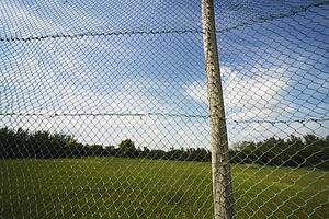 alberta, canada; a chain link fence attached to a wooden pole