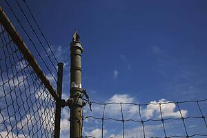 camrose, alberta, canada; a chain link fence with barbed wire