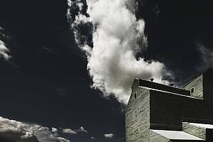 camrose, alberta, canada; a grain elevator and clouds in the sky