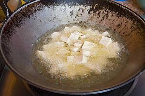 tofu frying in the wok