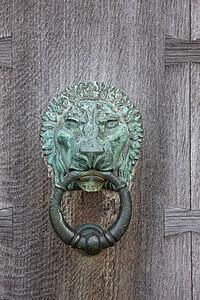 Northumberland, England; An Iron Lion Door Knocker On A Wooden Door