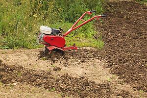 torremolinos, malaga, andalusia, spain; a motor hoe in a partly ploughed field